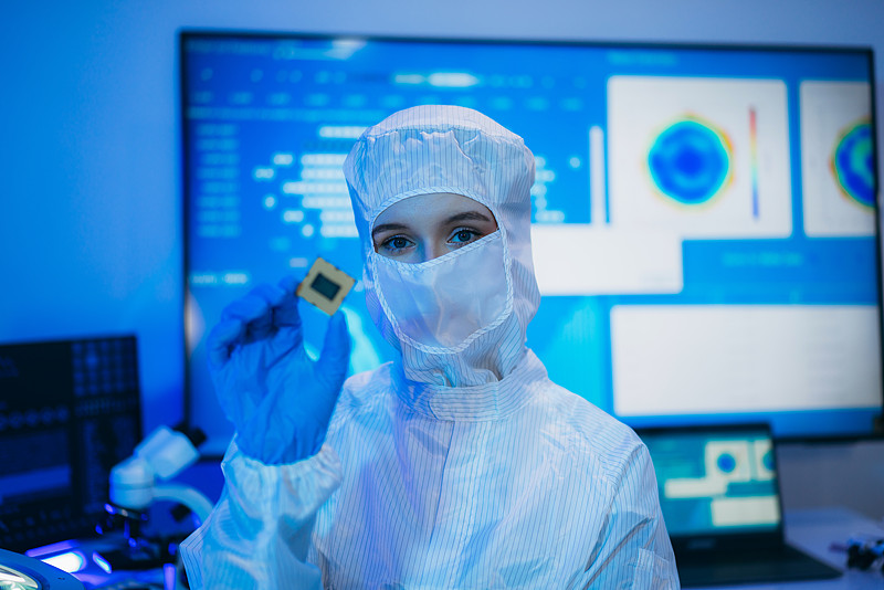 Cleanroom worker holding a semiconductor chip